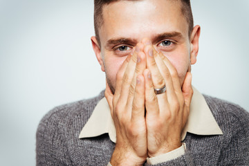 man laughs and covers her mouth