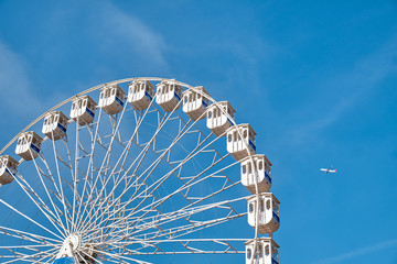 Ferris wheel and a plane. Lisbon, Portugal.