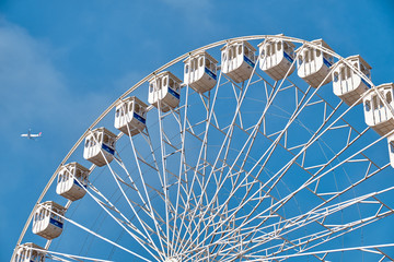 Ferris wheel and a plane. Lisbon, Portugal.