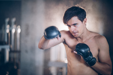 young man exercises with a boxing