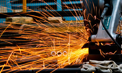 closeup of worker on Grinding sparks when sawing
