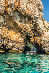 Whole in a cliff along the coast at the amazing blue caves of northern Zakynthos