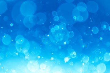 White bokeh on a blue background .Blue  bokeh background. Blur background. White bubbles.