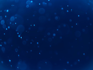 White bokeh on a blue background .Blue bokeh background. Blur background. White bubbles.
