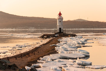The famous Tokarevsky lighthouse on the Egersheld peninsula in Vladivostok on a winter morning at...