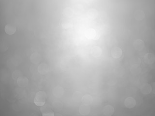 White and gray  bokeh background.Abstract blur background. White bubbles on a black background.