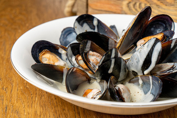 mussels in blue cheese on white plate