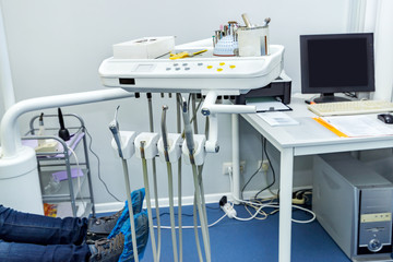 Medical dental tools closeup in dental office. Patient lying is being examined by a dentist