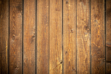  Background in grunge style. Wooden old fence with scuffs. From vertical boards of brown color. With dark vignette around the edges.