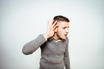 Overhears a man, tries to listen.