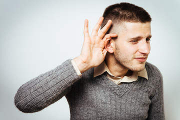 Overhears a man, tries to listen.