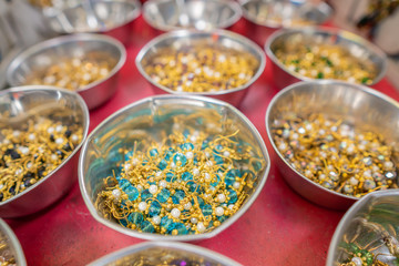 Bunch of Mukkera or Nose Rings or Nose Pins in a Bowl on shop