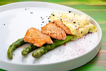 Salmon on asparagus with turmeric and shrimp sauce.
