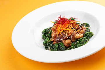 Fried shiitake mushrooms with spinach. Vegetarian dish.