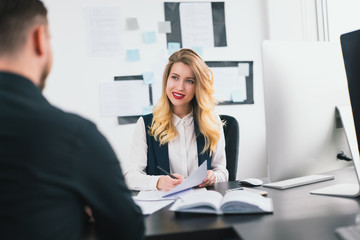 young woman hr manager interviews candidate in her modern bright office, , multitasking, employment concept