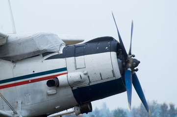 Fototapeta na wymiar Authentic realistic plane with propellers on a cloudy background
