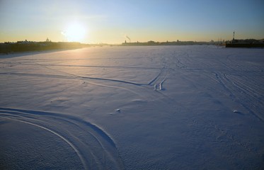 Sunset in the city. Saint-Petersburg, Russia. Frozen Neva river.