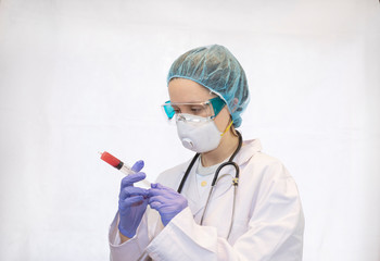 Fototapeta premium nurse or doctor with her protective equipment on with a syringe in her hand