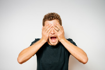 Man closes eyes with her hands