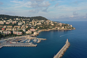 Fototapeta na wymiar Port of nice, France, shooting from the air. Cote d'azur, the blue sea water. Rocky beach. The Harbor lighthouse.