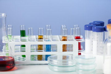 Laboratory equipment on blue background. Studio shot.