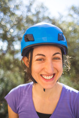 Portrait of a woman in a blue safety helmet.