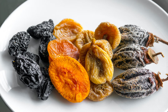 dried fruits lie on a white background, all kinds, rice, dried apricots, peach and grusha