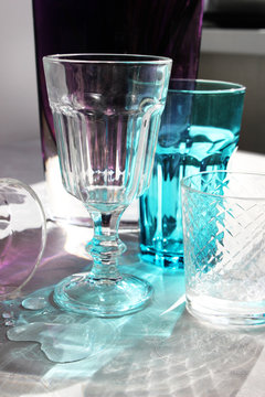 glasses of glass stand on a table in the rays of sunlight