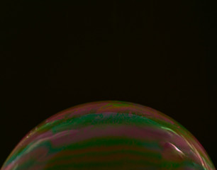 half soap bubble on a black background