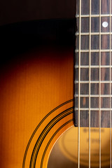 Obraz premium Sound hole of an acoustic guitar, neck, strings, frets, the nut.