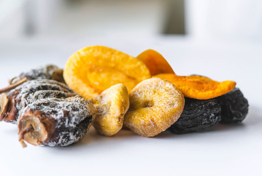 dried fruits lie on a white background, all kinds, rice, dried apricots, peach and grusha.Copy space