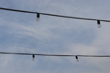 light bulb hanging on cable at street