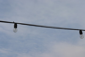 light bulb hanging on cable at street