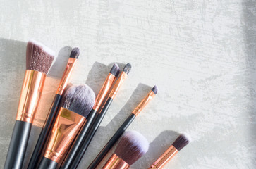 Fototapeta na wymiar premium makeup brushes on a marble background, creative cosmetics flat lay, tools for make up