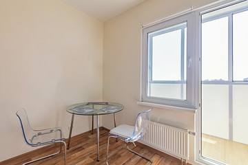 round table and two chairs near by in the kitchen