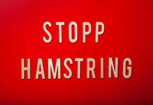 stopp hamstring norwegian word text wooden letter on red background coronavirus covid-19