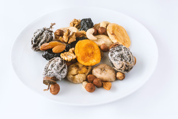 different kinds of nuts and dry fruits in a plate.