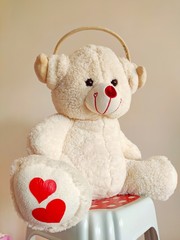 Cute white teddy bear wearing headphones