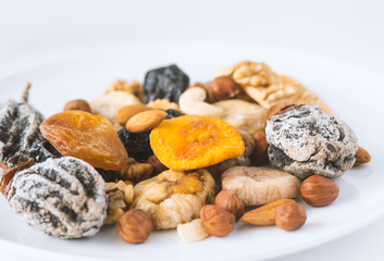 different kinds of nuts and dry fruits in a plate.