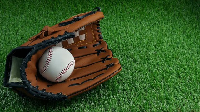 Baseball Catcher's Mitt And Ball On The Pitch