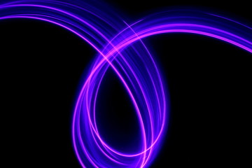 Long exposure photograph of neon purple streaks of light in an abstract swirl, parallel lines pattern against a black background. Light painting photography.