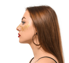 Naklejka premium Fashionable young woman with glitters on her body against white background