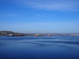 Fototapeta premium Cargo ships stand in the roadstead on the Volga River near Saratov