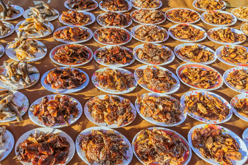 Many kinds of deep fried fish on dish for sale at street food in Thailand.