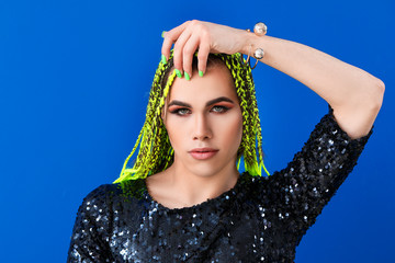 Portrait of young transgender woman on color background
