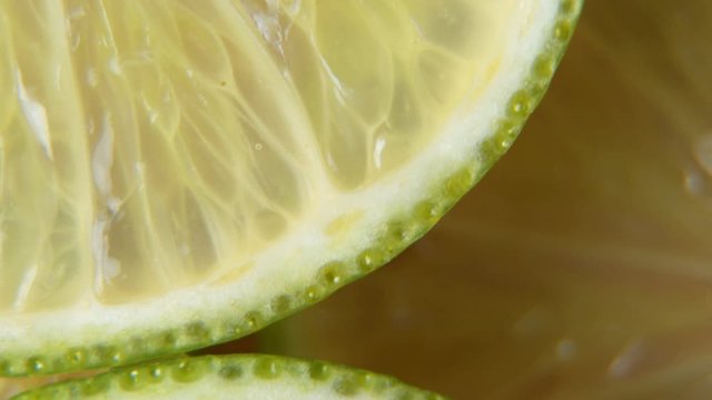 A sliced lime slice rotates on the table. Macro shot