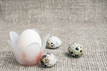 Composition of Easter eggs on a background of rough canvas