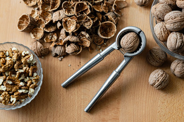 walnuts and nutcracker on wooden background