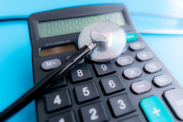 Health care costs. Stethoscope and calculator symbol for health care costs or medical insurance