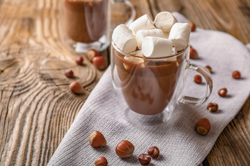 Cup of hot chocolate with marshmallows on table